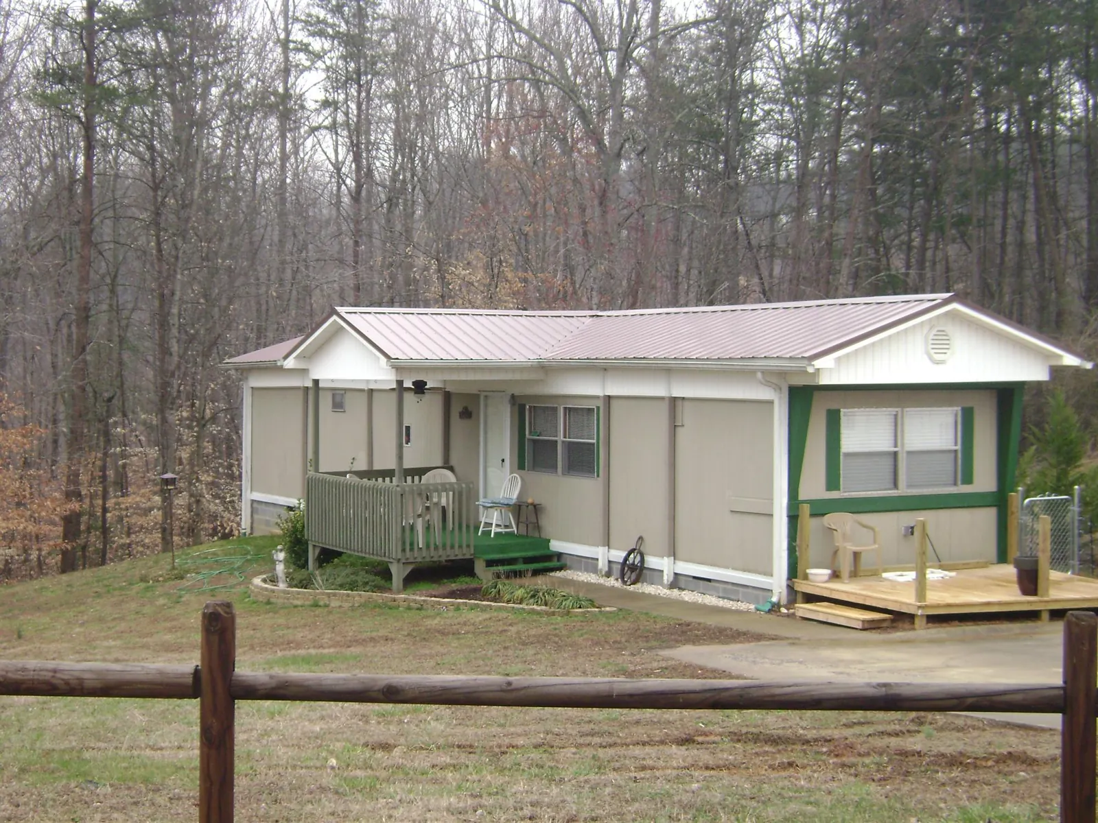 Mauve metal roof on a manufactured home with a new front deck in Holland Patent